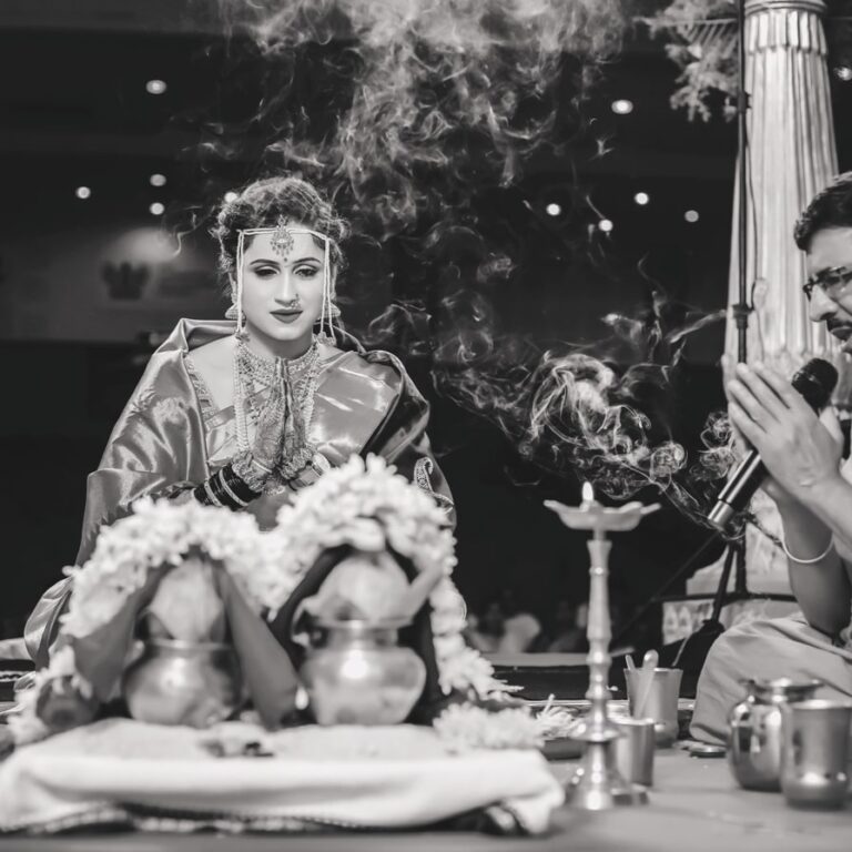 Candid picture of bride praying to the kalash