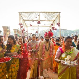 candid picture of bride and groom grand entry to marriage hall with family
