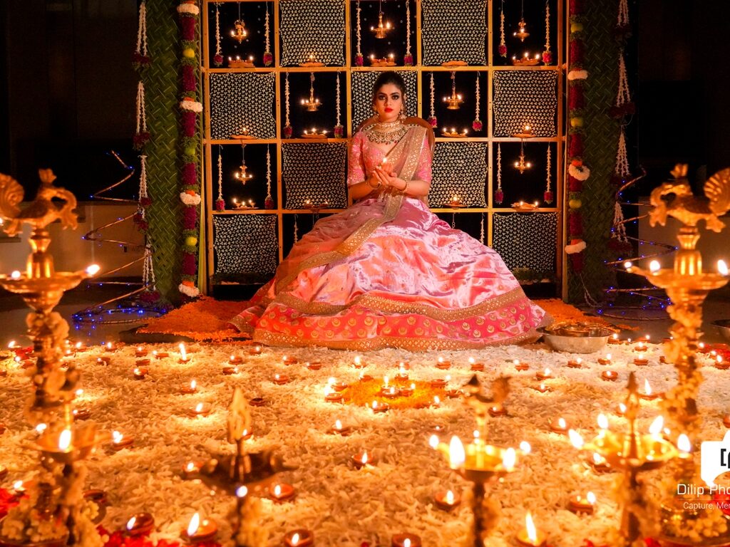picture of bride sitting and holding a lamp in a decorated background