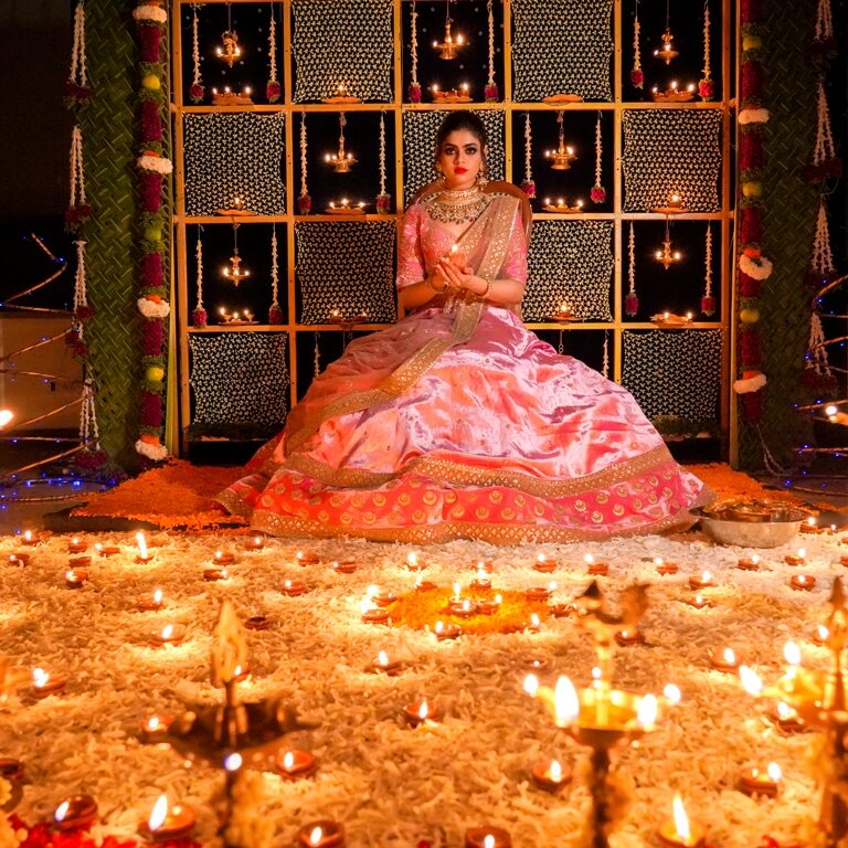 picture of bride sitting and holding a lamp in a decorated background