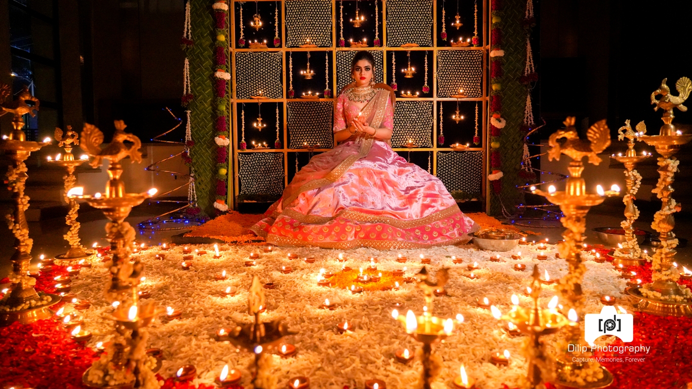 picture of bride sitting and holding a lamp in a decorated background