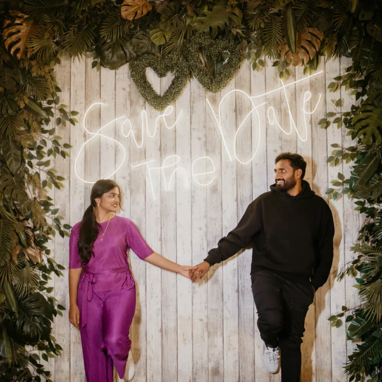 Excited couple holding hands, smiling in a pre-wedding 'Save the Date' shoot