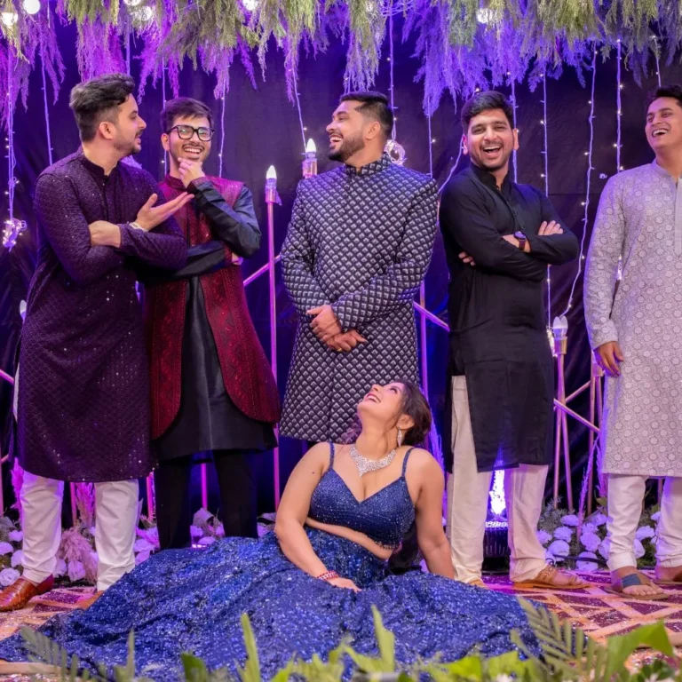 Candid wedding photography of Pranjal and Vineeta posing for a photo with friends.