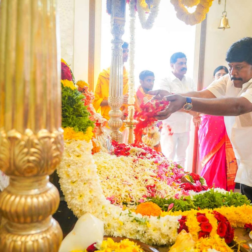 candid moment of praying and offering shiva god with flowers